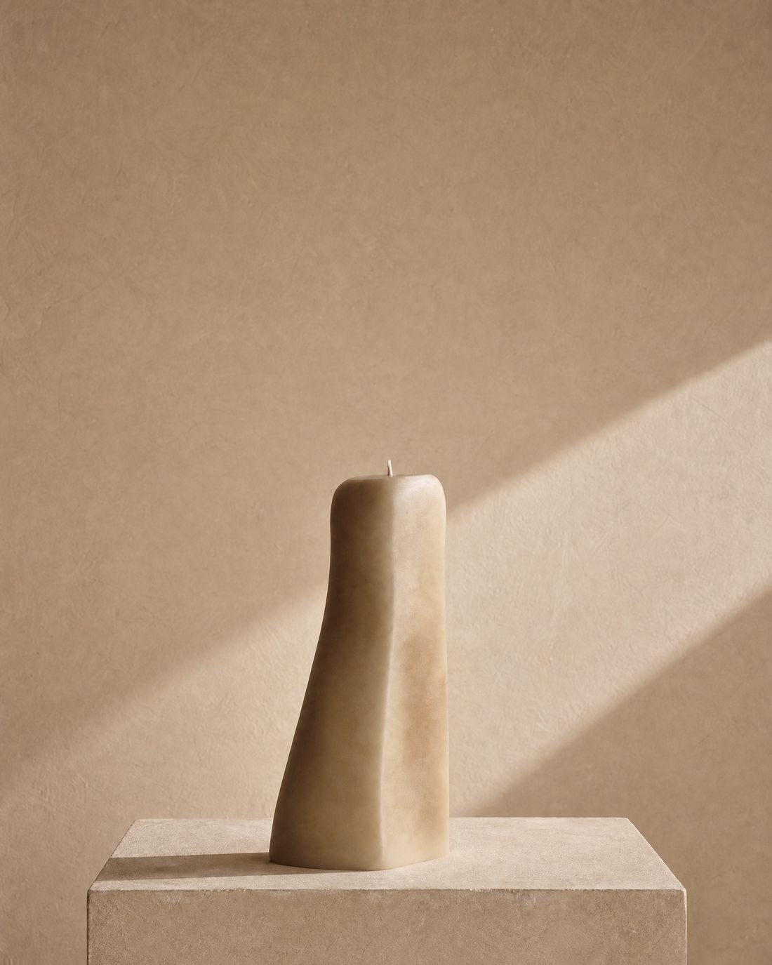 A Homey candle standing in soft light, part of the daily ritual